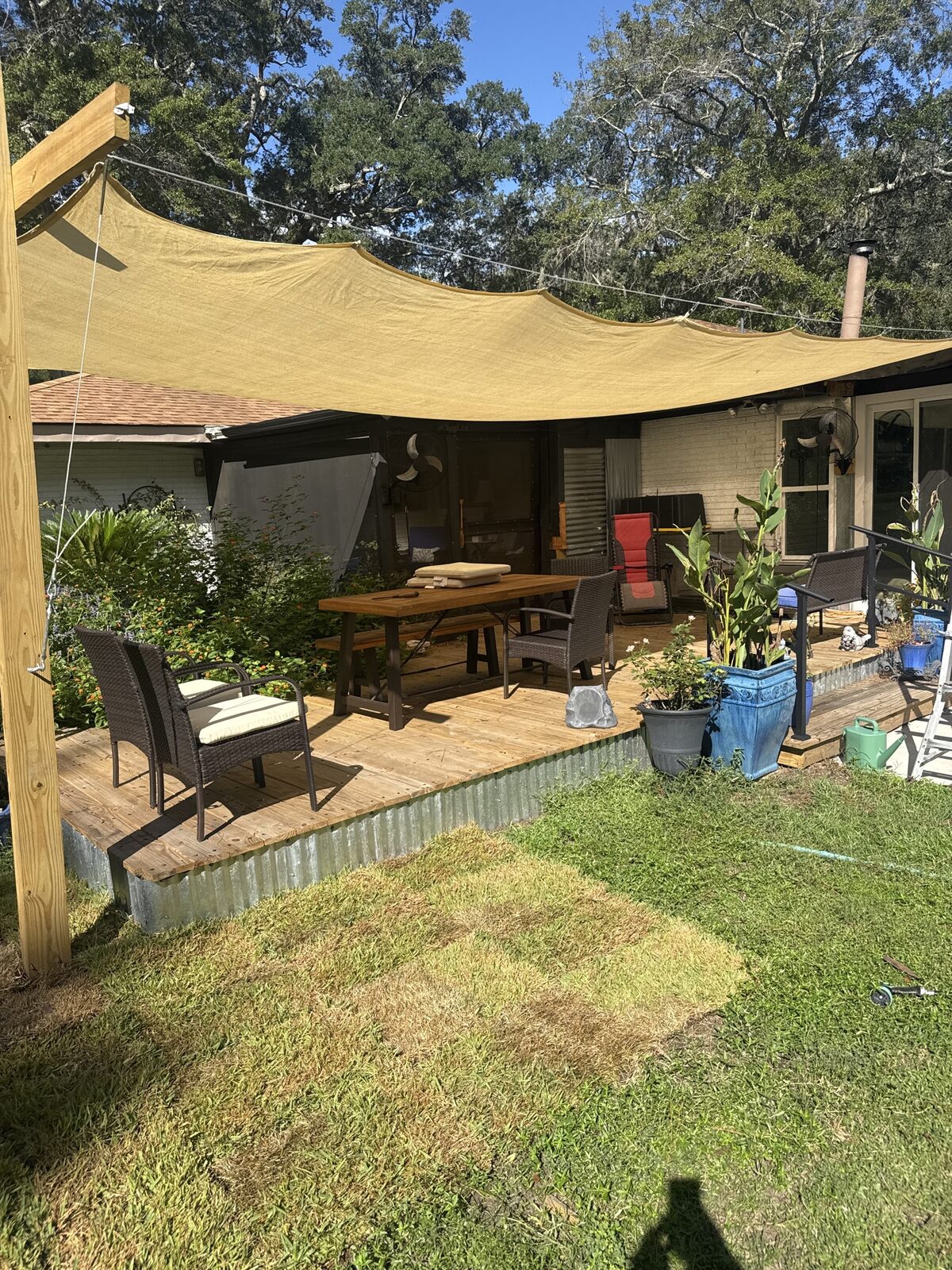 Finished PALLET-DEX backyard platform with shade sail and seating.
